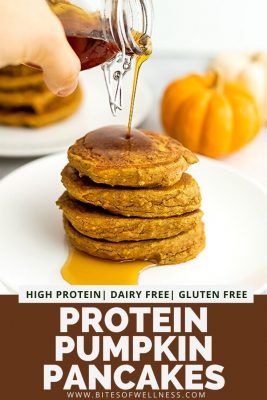 High protein pumpkin pancakes stacked on a white plate getting syrup poured over them