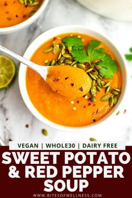Spoon in a bowl of sweet potato red pepper soup.