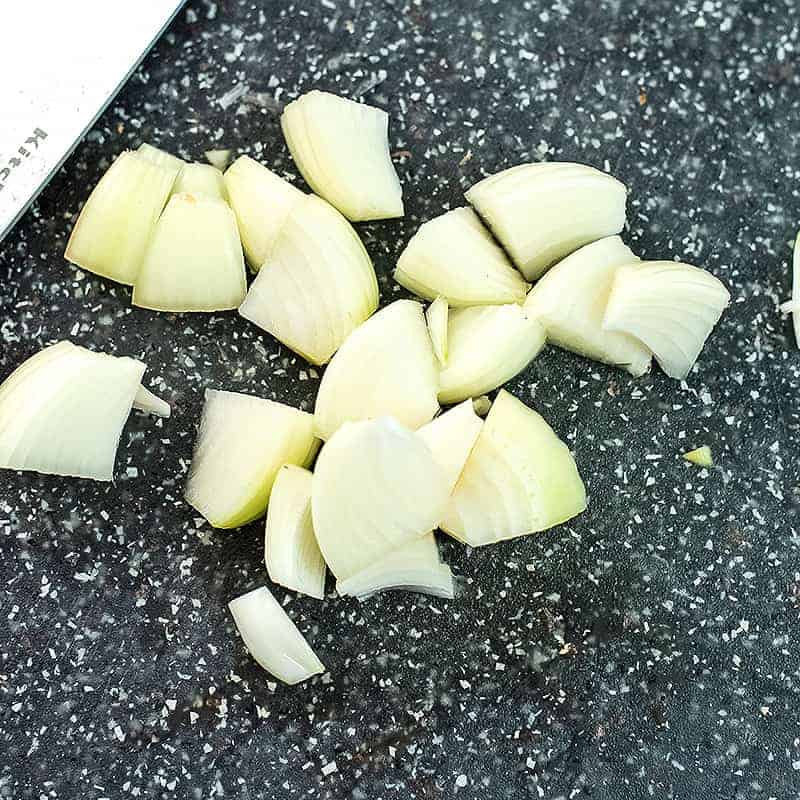 Chopped white onion on a cutting board.