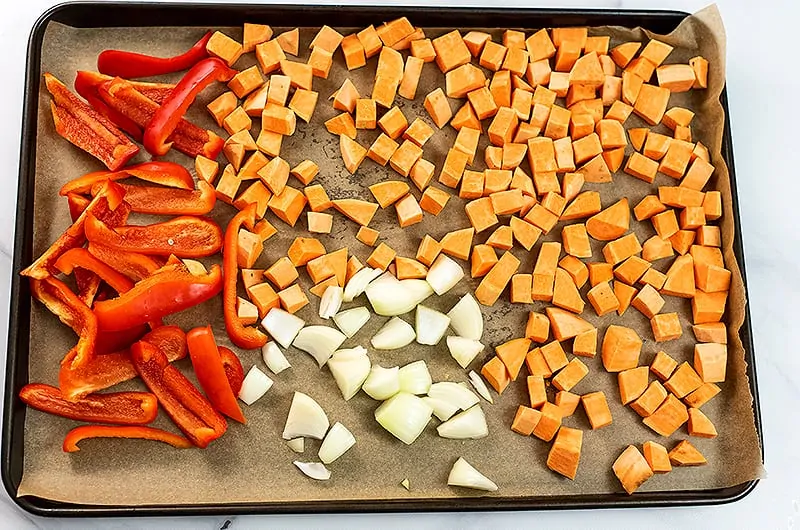 Vegetables for sweet potato red pepper soup before roasting.