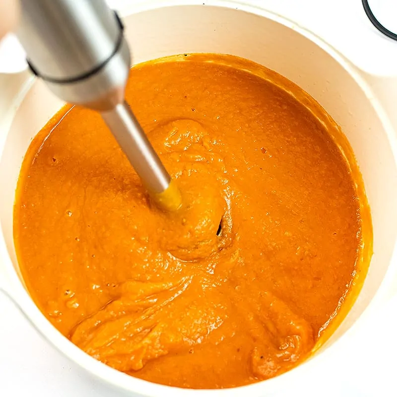 Immersion blender blending the sweet potato red pepper soup.