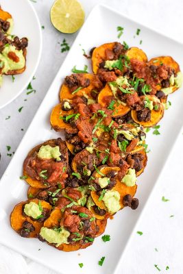 Rectangular plate filled with black bean sweet potato nachos.