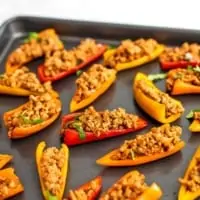 Gray baking sheet filled with mini pepper nachos.