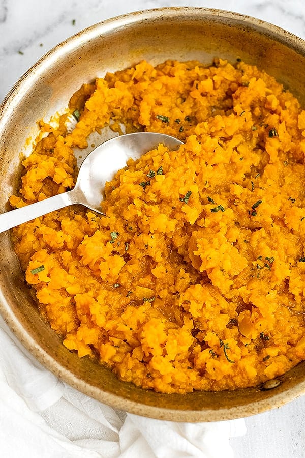 Stainless steel pan filled with butternut squash risotto.