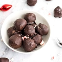 Chocolate mint energy balls in a white bowl.