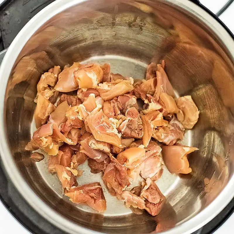 Cubed chicken in instant pot.
