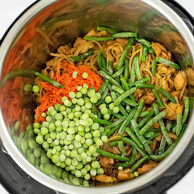 Frozen veggies added to the Asian chicken with noodles instant pot.