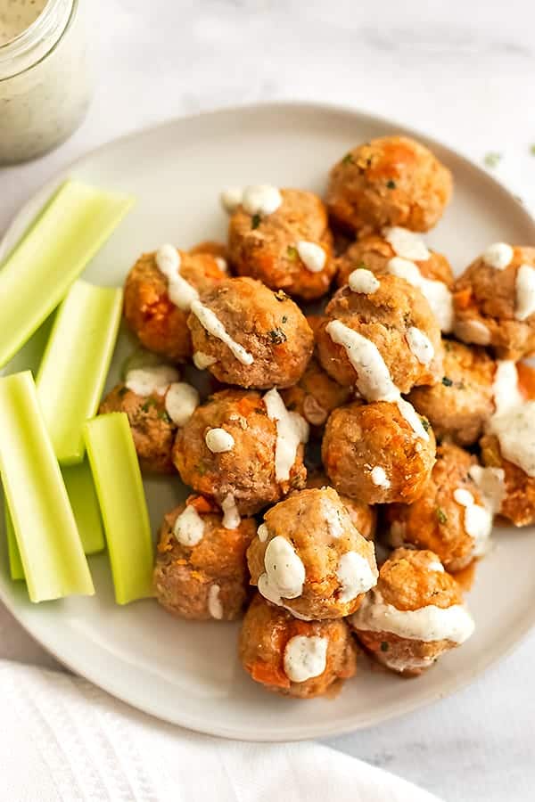 Ranch dressing drizzled over buffalo turkey meatballs.