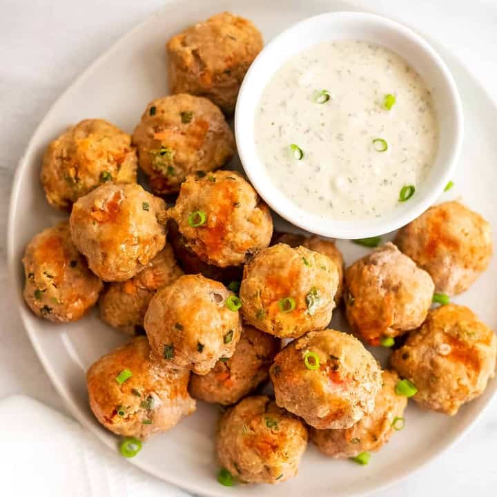 Buffalo Turkey Meatballs on a white plate with a side of ranch.