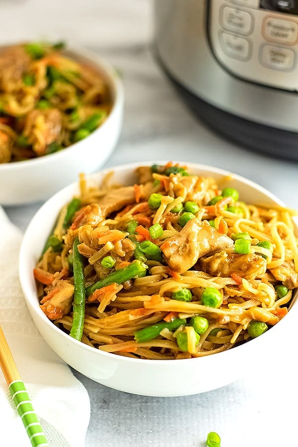 White bowl filled with Asian Chicken and noodles.