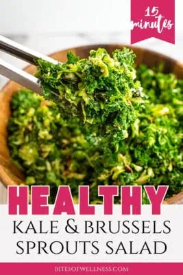 Tongs picking up kale brussel sprouts salad from wood bowl.