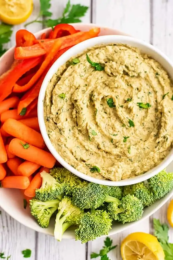 Bowl of baba ganoush with an assortment of cut veggies.