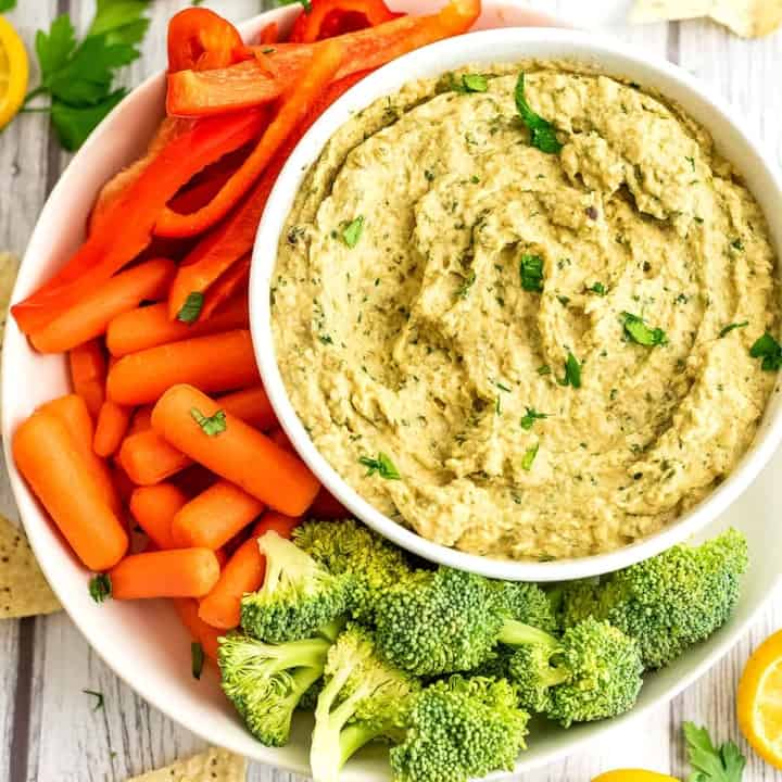 Baba ganoush in a white dip with assorted veggies on the side.