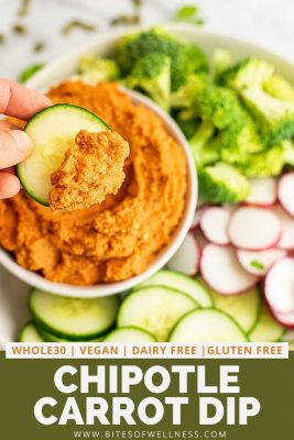 Cucumber topped with spicy carrot dip with a tray of veggies.