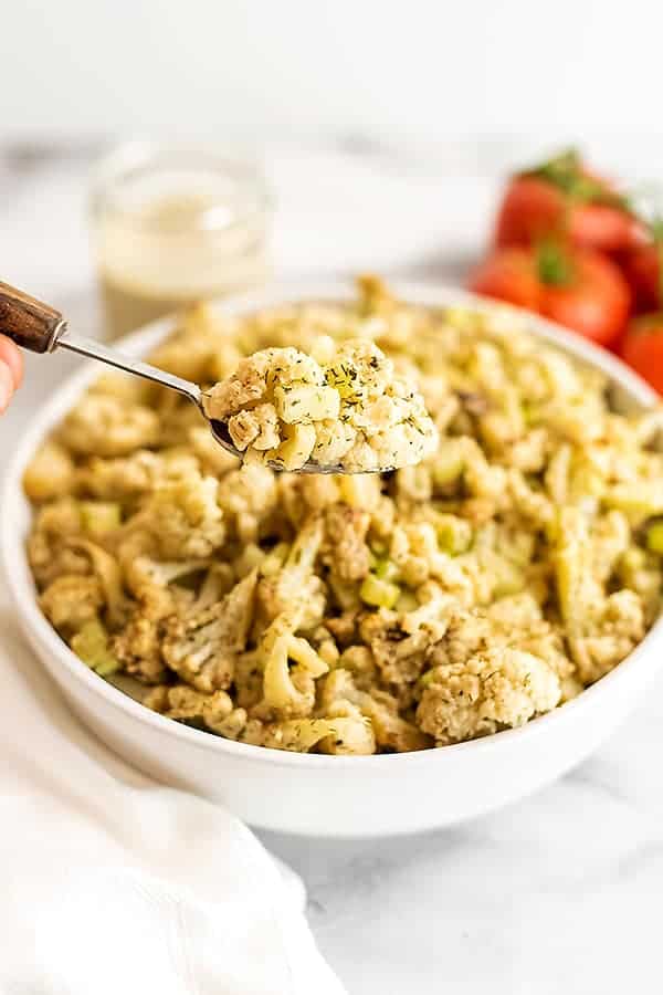 Spoon scooping a serving of cauliflower potato salad.