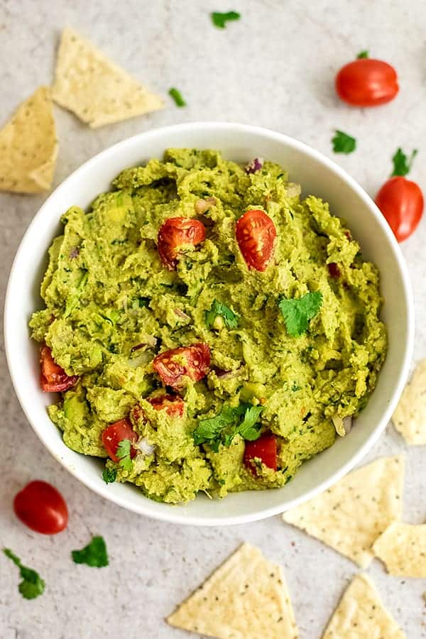 Large bowl filled with roasted cauliflower guacamole.