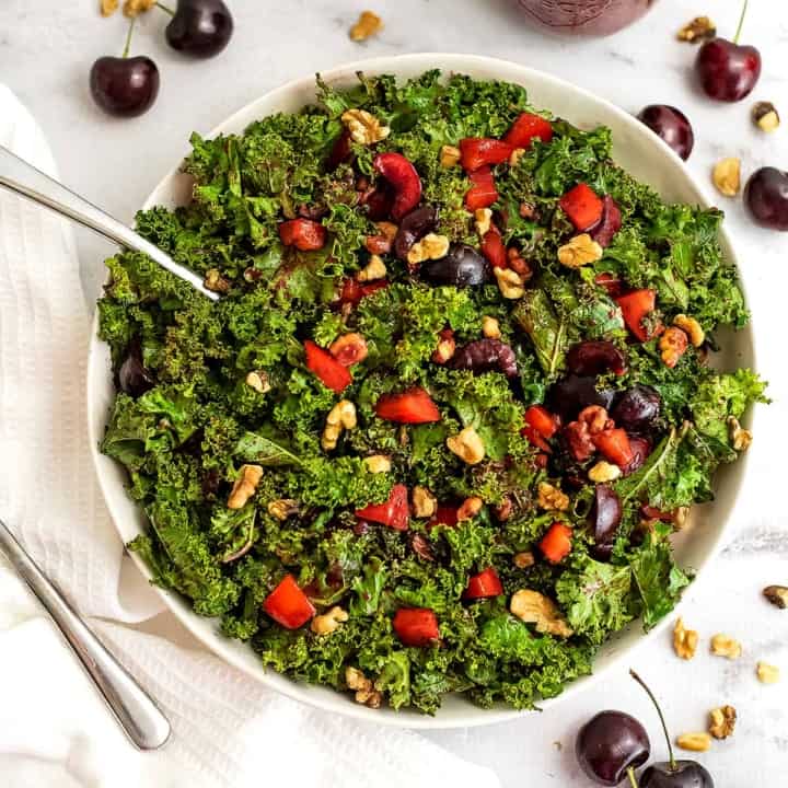 Bowl of cherry kale salad with a fork in the bowl.