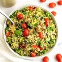 Italian quinoa salad in a large white bowl with fork in salad.