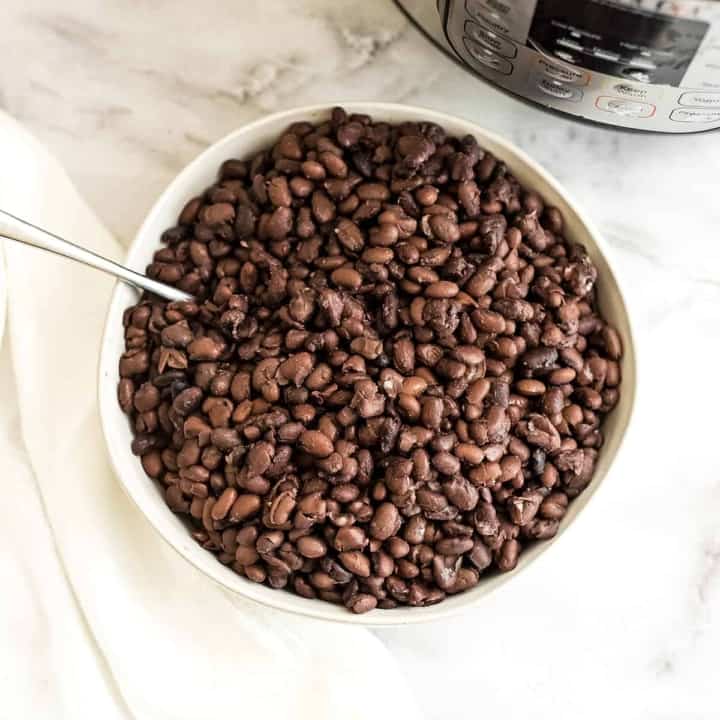 Bowl filled with black beans made in Instant Pot.