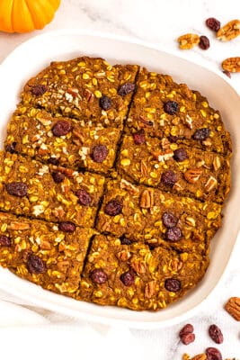 White baking pan with sliced pumpkin oatmeal bars.
