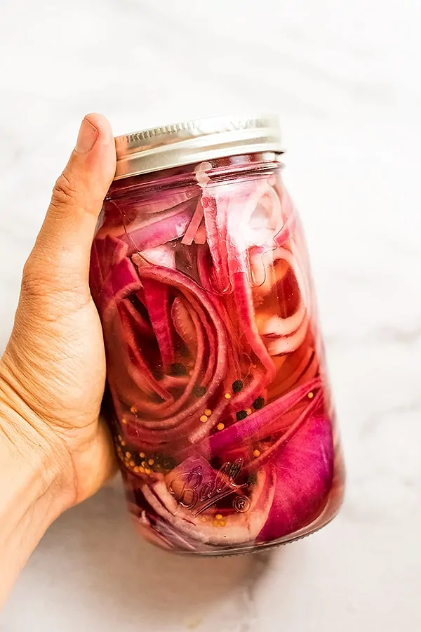 Glass jar of Whole30 pickled red onions.