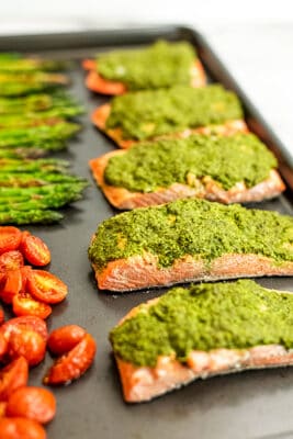 Pesto salmon baked on a sheet pan.