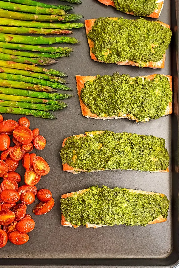 Sheet pan with pesto crusted salmon and vegetables.