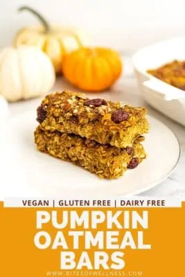 Two pumpkin oatmeal breakfast bars stacked on top of a plate.