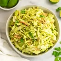 Creamy cilantro lime slaw in a white bowl.