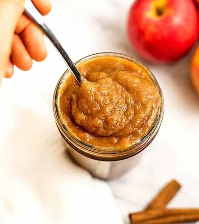 Spoon in a jar of paleo apple butter.