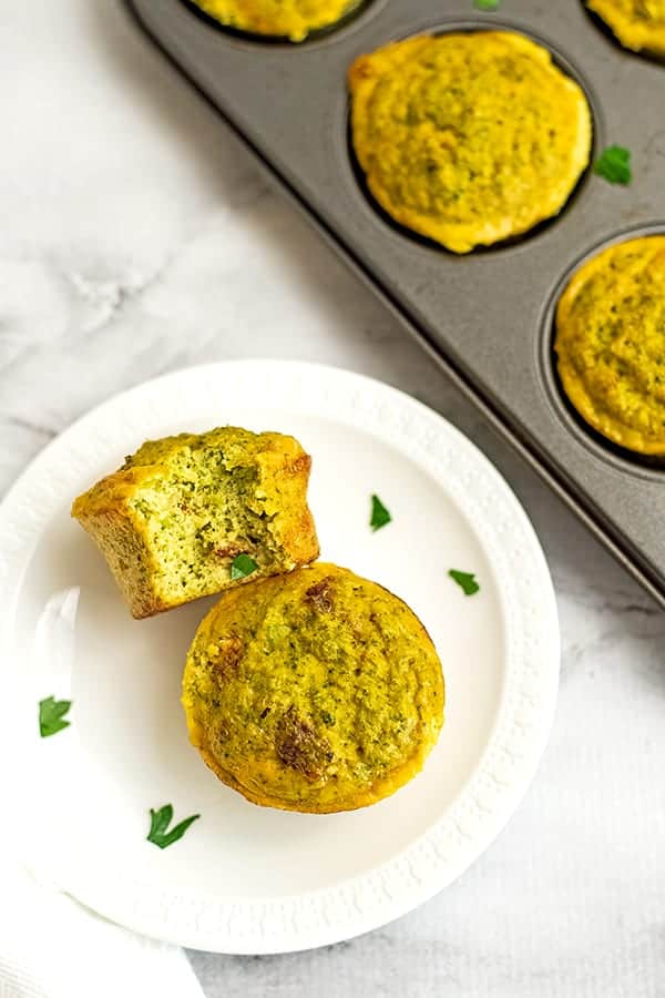 Egg muffins on a white plate with a bite taken out of one.