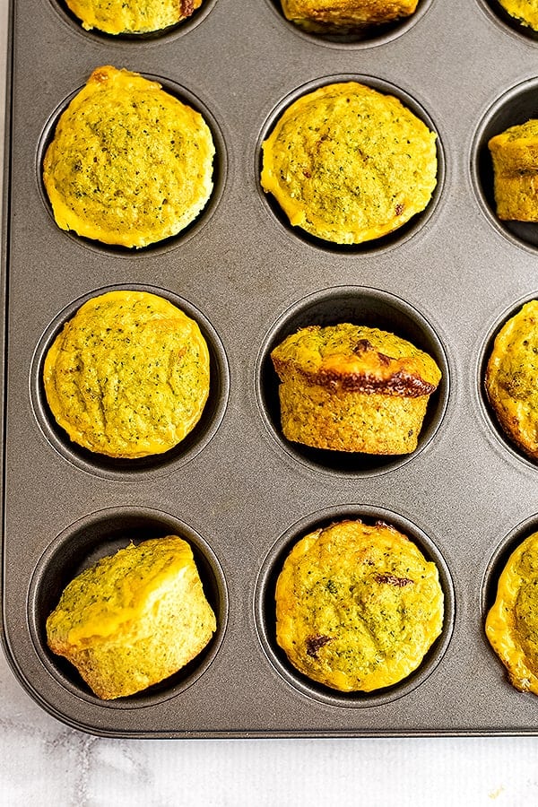 Whole30 cheesy broccoli egg muffins in a muffin tin.