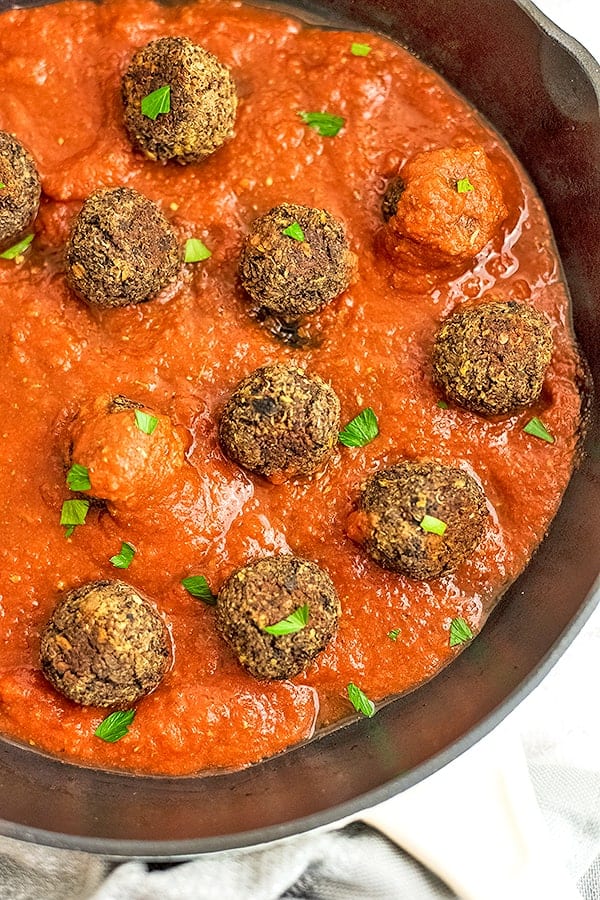 Quinoa Lentil Mushroom Meatballs in a red sauce in a skillet