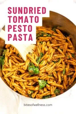 Large pot filled with sundried tomato pesto pasta.