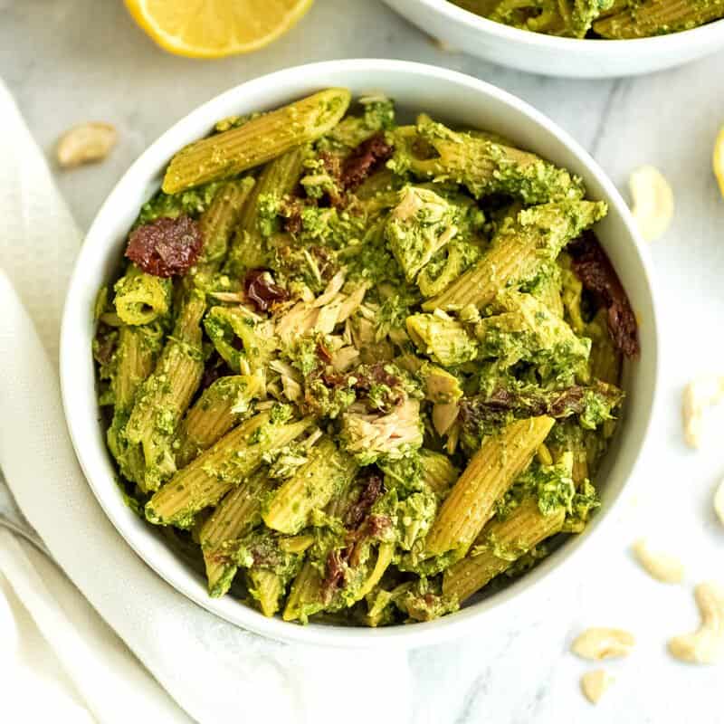 Bowl filled with pesto tuna pasta.