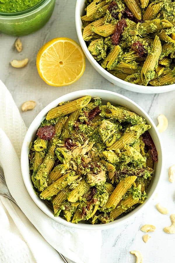 Bowl of pesto tuna pasta with a fork to the side.
