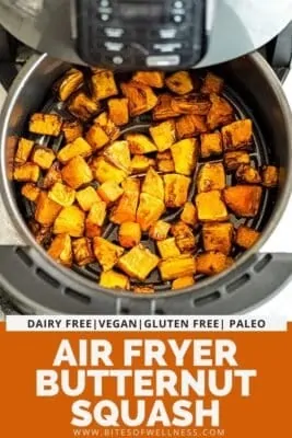 Air fryer basket filled with butternut squash cubes.