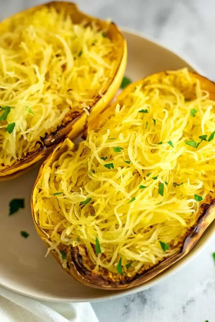 Spaghetti squash after cooking on a white plate.