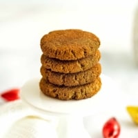 Paleo molasses cookies stacked on top of each other.