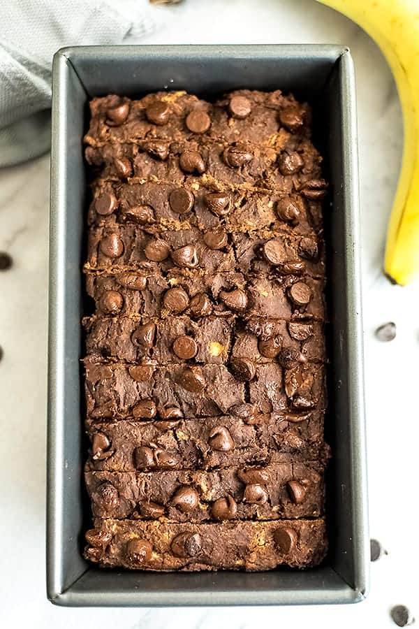 Chocolate protein banana bread in a loaf tin, sliced.
