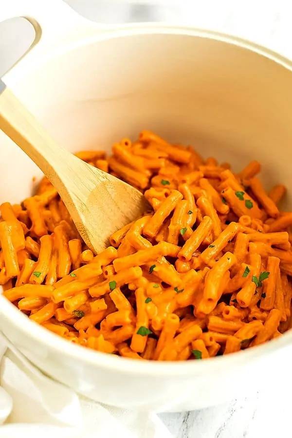 Large pot filled with creamy roasted red pepper pasta.