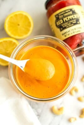 Spoon full of vegan roasted red pepper sauce.