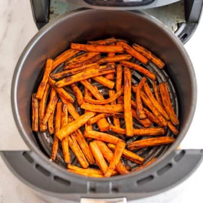 Air fryer carrots in the basket of the air fryer.