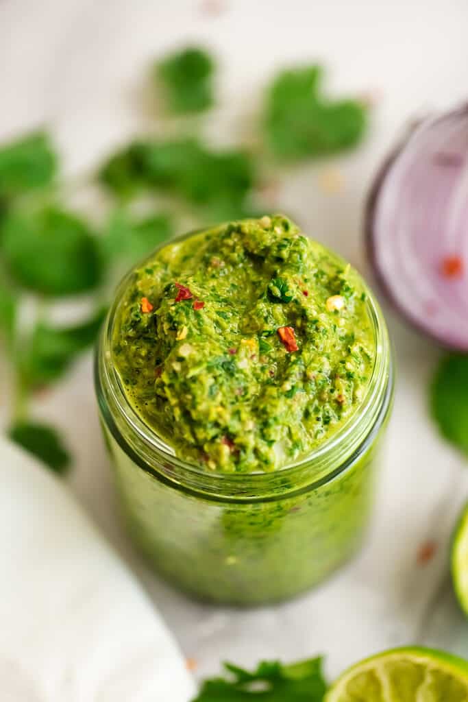 Glass jar filled with whole30 chimichurri sauce.