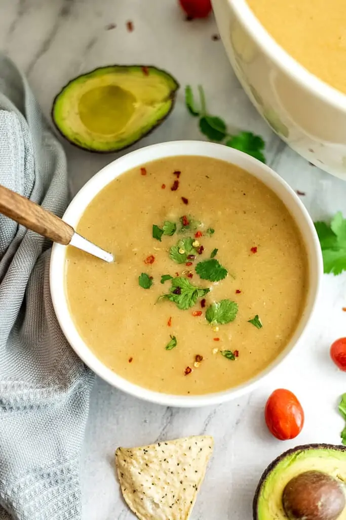 Bowl of cauliflower white bean soup with a spoon in the bow.