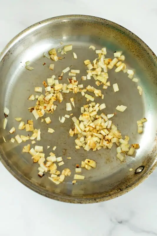 Onion sauteed in stainless steel pan.