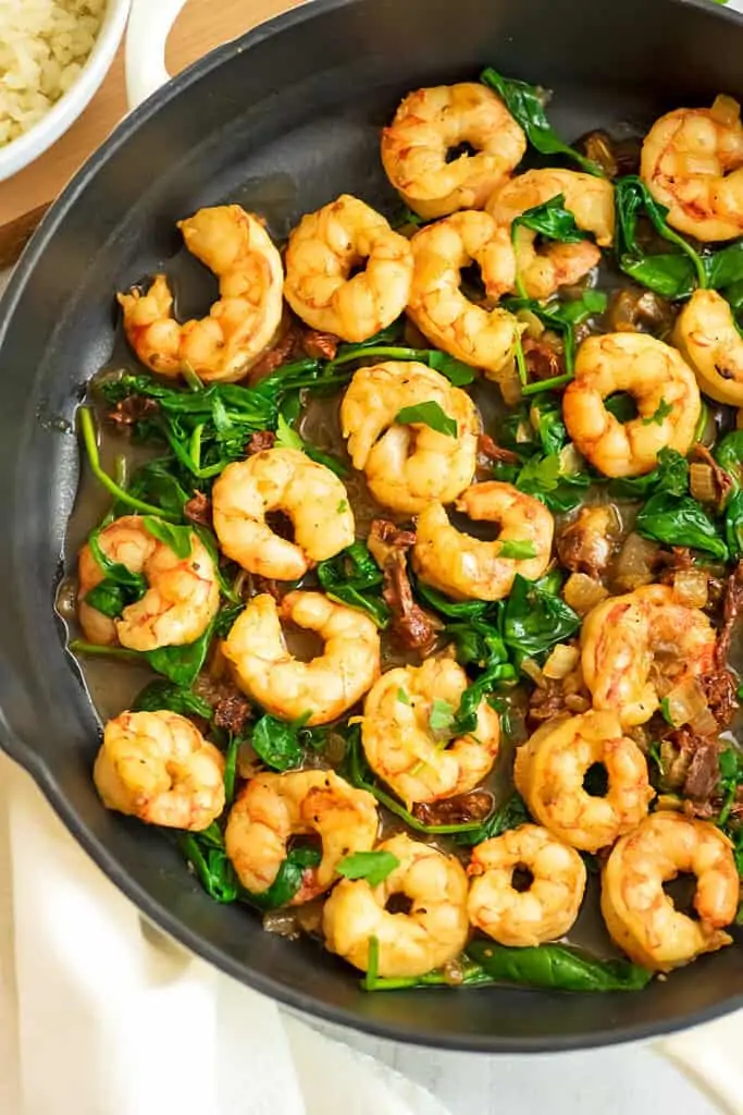 Skillet filled with sun dried tomato shrimp.