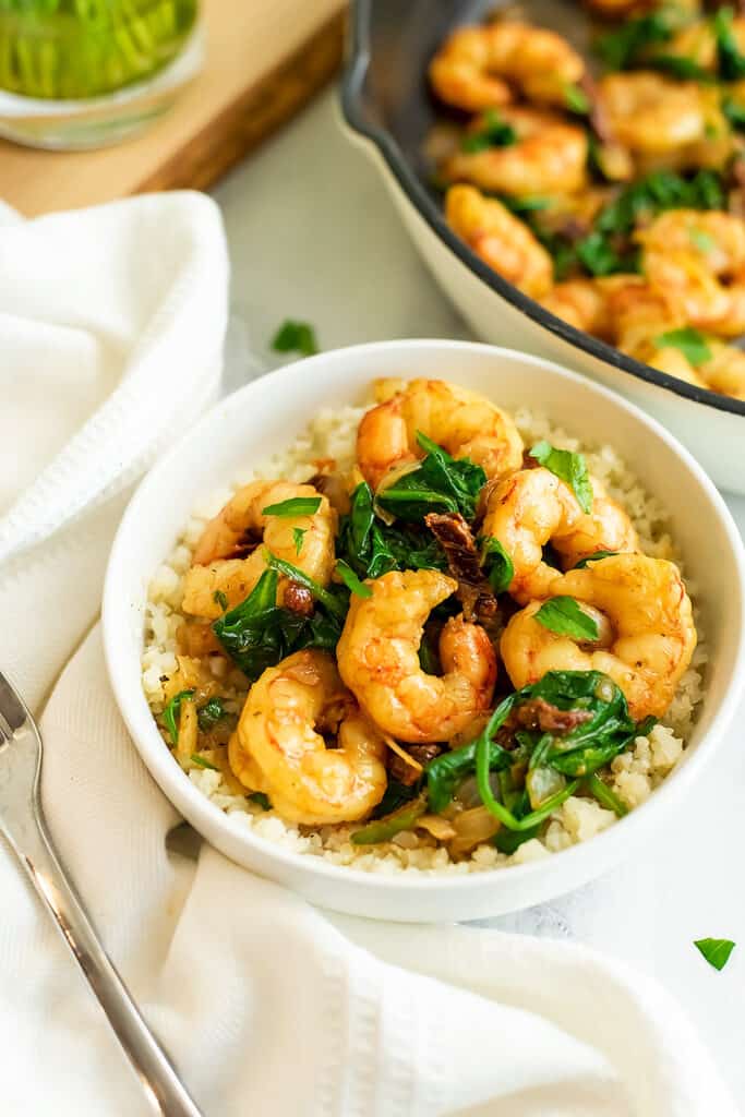 Bowl filled with sun dried tomato shrimp and cauliflower rice.