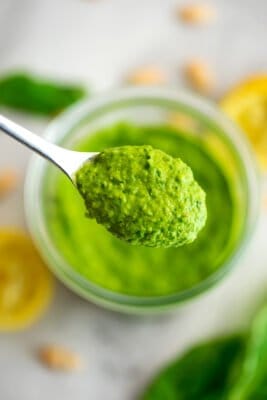 Spoonful of white bean pesto over a jar.