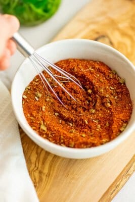 Low FODMAP taco seasoning being whisked in a bowl.